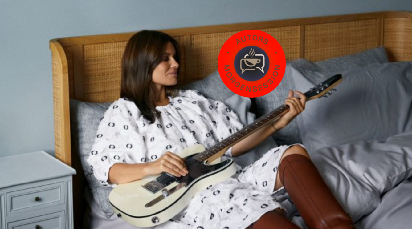 Pernille Rosendahl spiller guitar på en seng.